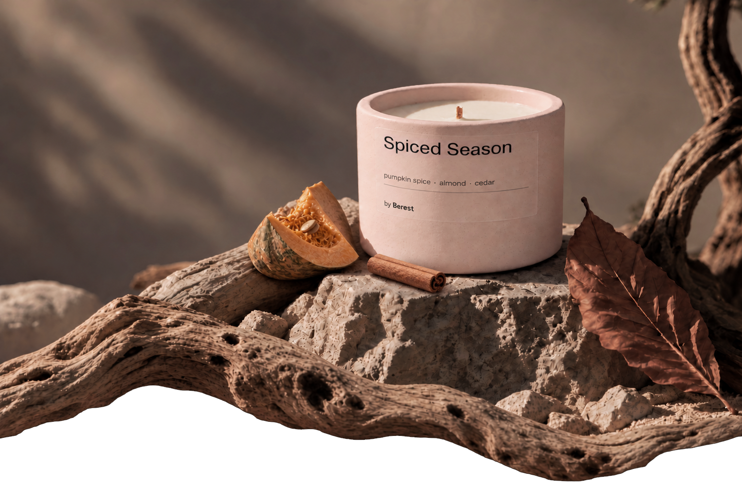 Harvest Haze candle on limestone, surrounded by autumn leaves, pumpkin and driftwood